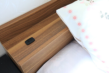 Outlet next to the bed